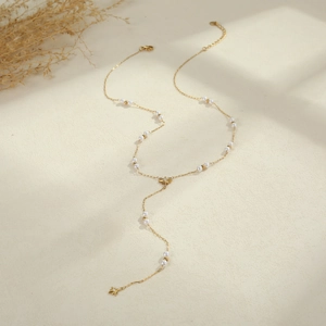 Elegant gold Y-shaped stainless steel necklace featuring faux pearls and star pendants