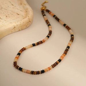 Detail of vintage beaded necklace with tiger eye stones and gold stainless steel clasp
