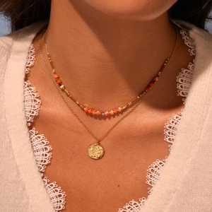 Double-layered gold-plated stainless steel necklace with orange beads and celestial pendant