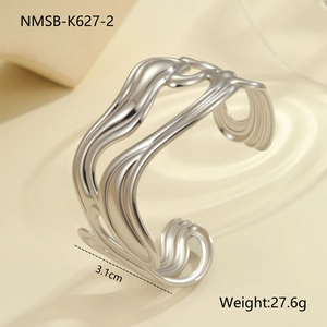 Macro detail of wide silver liquid wave textured open cuff bracelet for women