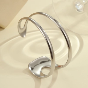 Detailed view of polished silver cuff bracelet with double band design and mirror finish