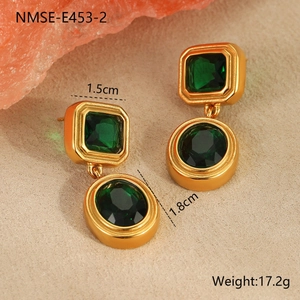 Detail shot of 18K gold earrings with emerald green zircon measuring 1.5cm by 1.8cm