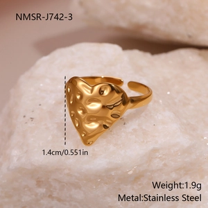 Macro detail of gold heart ring showing 1.4cm hammered texture and adjustable opening