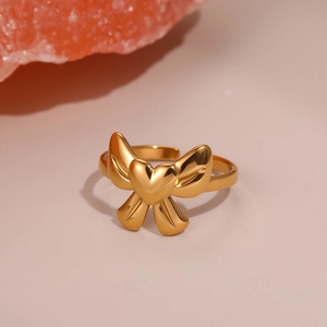 Golden heart bow ring in polished stainless steel with adjustable open band design