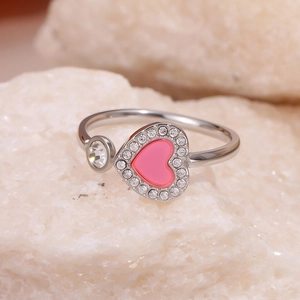 Adjustable silver heart ring with pink stone and zircons on white natural stone