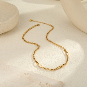 Detailed macro view of 18K gold-plated O-chain and rectangle links with lobster clasp