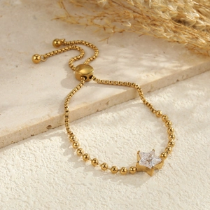 Detail of adjustable gold-plated stainless steel star zircon bracelet with sliding clasp