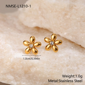 Macro shot of 1cm stainless steel gold floral stud earrings with clear crystal centers