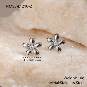 Macro detail of stainless steel flower earrings featuring a central sparkling zircon stone