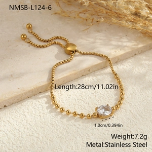 Detail showing gold adjustable stainless steel bracelet with a round zircon stone on stone