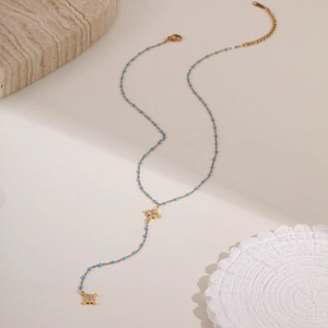 Collar en Y dorado minimalista con cuentas turquesas y colgantes de estrellas de circón