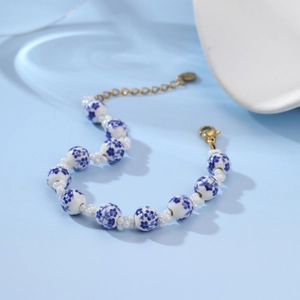 Detail of floral ceramic bead bracelet with pearls and gold-plated lobster clasp