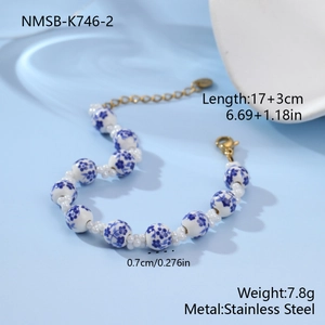 Detailed macro view of 17cm ceramic floral bead bracelet with stainless steel lobster clasp