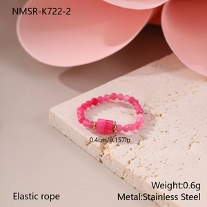 Detailed macro view showing the 0.4cm pink stone beads and elastic cord of the gold ring