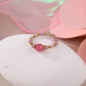 Pink natural stone beaded ring with 18K gold plated accents on white pebble