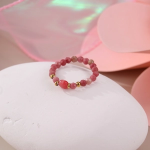 Macro view of beaded natural pink stone ring with 18K gold-plated stainless steel beads