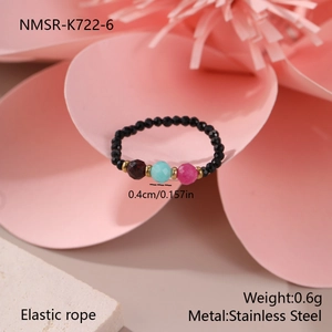 Detail of elastic beaded ring with colorful natural stones and stainless steel spacers