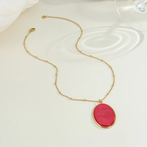Collana vintage dorata con pendente in pietra ovale magenta e catena a sfere raffinata