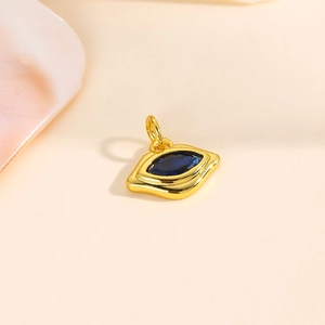 Detailed close-up of 18k gold plated evil eye lip pendant with blue cubic zirconia stones