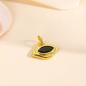 Close-up of gold 18k plated lip-shaped pendant with a black diamond-cut zircon stone
