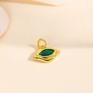 Macro detail of eye-shaped gold pendant with marquise-cut green zircon for DIY jewelry