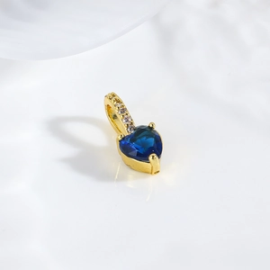 Detail view of a 18k gold plated heart pendant with blue zircon and white diamonds