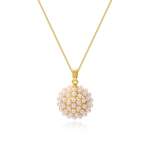 Close-up of golden necklace featuring a spherical pendant pavé-set with small white pearls