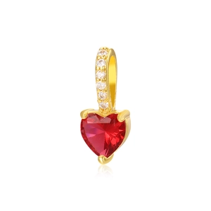 Detail of red heart-shaped gemstone pendant with 18k gold-plated diamond-set loop
