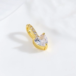 Macro shot of 18k gold plated heart pendant with sparkling cubic zirconia inlay
