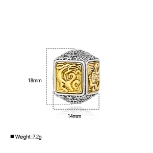 Macro view of ethnic style cube bead with golden relief and silver finish details