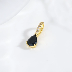 Macro detail of teardrop black zircon pendant with 18k gold plated bail and micro pavé crystals