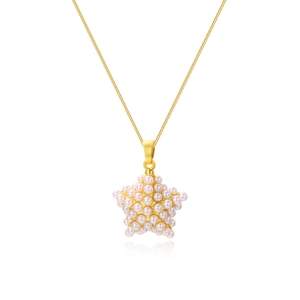 Detailed macro shot of a gold star pendant featuring elegant white pearls on a fine chain