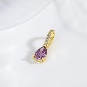 Macro shot of a purple teardrop zircon pendant with 18k gold plating for jewelry DIY