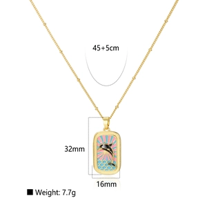 Detailed size view of a gold tarot pendant featuring a dolphin enamel design and waves