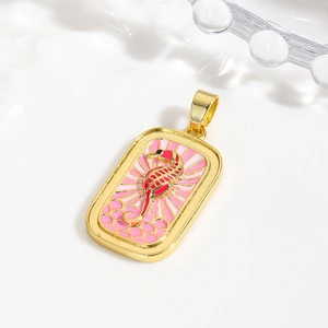 Macro shot of rectangular gold seahorse pendant with pink enamel and etched details