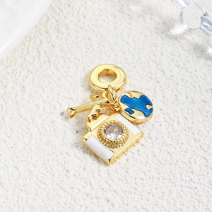 Detailed view of travel-themed charms featuring globe and camera with blue enamel