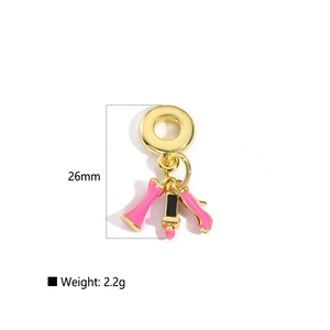 Detail showing 26mm gold-plated charm set with pink enamel lipstick and high heel