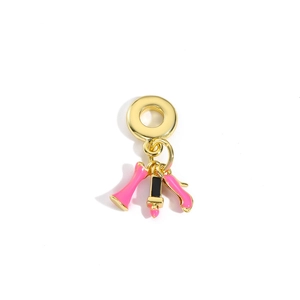 Macro detail of copper high heel lipstick and dress charms with pink enamel and gold plating