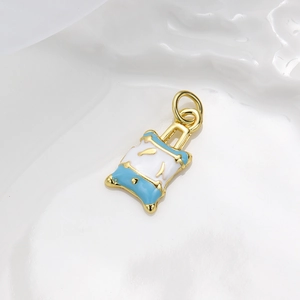 Detailed macro view of blue and white enamel luggage pendant with gold-plated finish