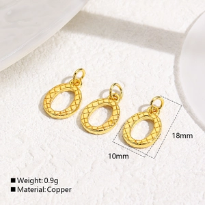 Macro detail of three 18k gold-plated oval charms with textured diamond grid pattern