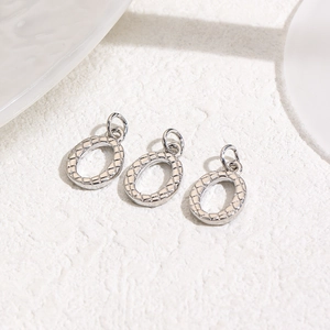 Macro view of three silver heart oval pendants with woven texture for DIY jewelry making