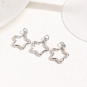 Macro shot of three polished silver star pendants for DIY jewelry making and crafts