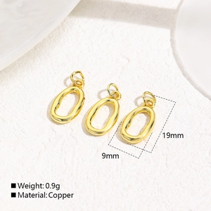 Macro view of three gold-plated copper oval pendants on a white stone background