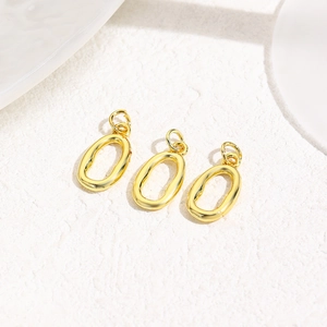 Three 18k gold-plated irregular oval charms for DIY jewelry making on white stone
