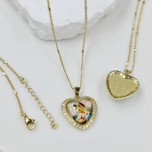 Close-up of golden heart Virgin Mary pendant with sparkling crystals and honeycomb back