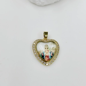 Macro detail of gold plated heart pendant with Virgin Mary icon and white zircon stones
