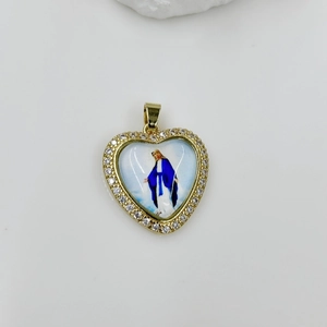 Macro detail of heart-shaped Virgin Mary pendant with gold finish and white crystals