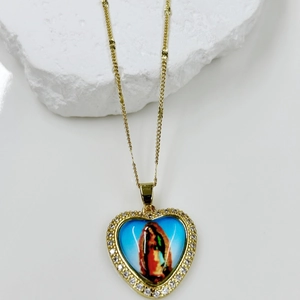 Detail of heart pendant necklace with Virgin Mary image and white zircon inlay
