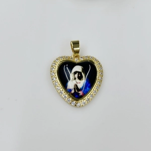 Macro detail of heart-shaped Virgin Mary pendant with gold finish and white zircon stones