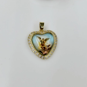 Detail of heart pendant with religious icon inlay and crystal-encrusted gold border